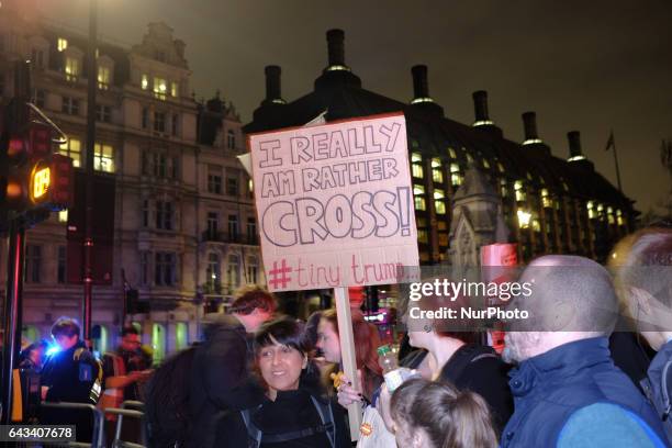 Protesters hold up placards during a rally in Parliament Square against US president Donald Trump's state visit to the UK on February 20, 2017 in...