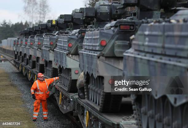 Railway worker checks Marder light tanks of the Bundeswehr, the German armed forces, after they had been loaded onto a train for transport to...