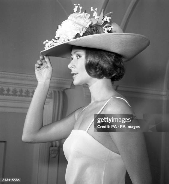 Aldine Honey models a swimsuit and hat at Christian Dior's London boutique.