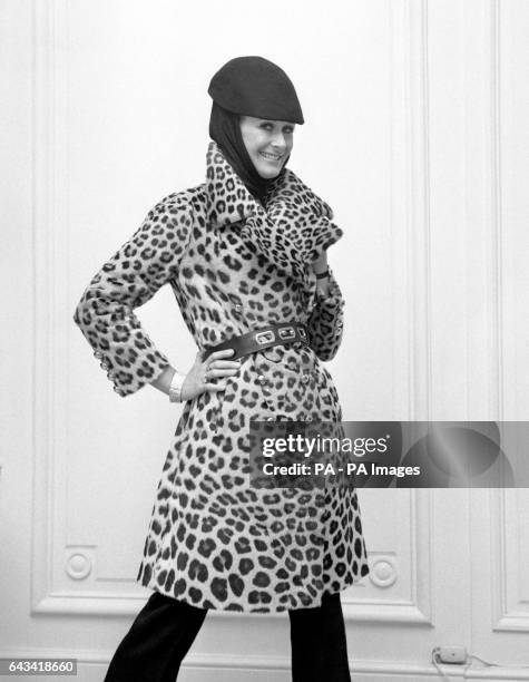 Aldine Honey wears a leopard trench coat priced at £5,000 and part of the House of Worth's Million Pound Fur Export Drive to Europe, shown at...