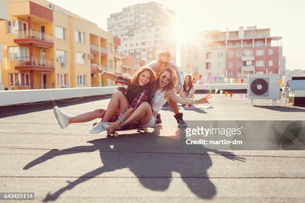freunde haben spaß auf dem dach - immobilie humor stock-fotos und bilder