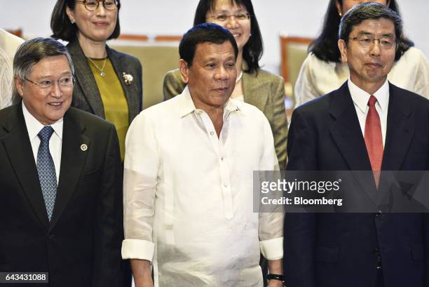 Rodrigo Duterte, the Philippines' president, center, Carlos Dominguez, the Philippines' secretary of finance, left, and Takehiko Nakao, president of...