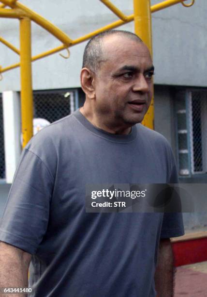 Indian Bollywood actor Paresh Rawal poses after casting his vote in civic elections in Mumbai on February 21, 2017. / AFP / STR