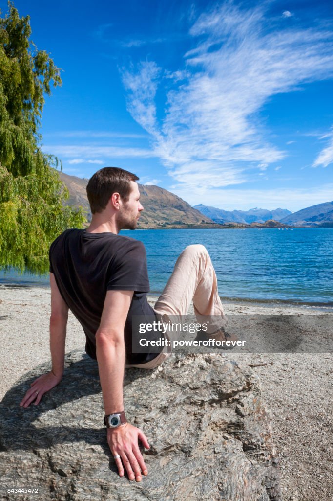 Tourist at Lake Wanaka in the Southern Alps of New Zealand