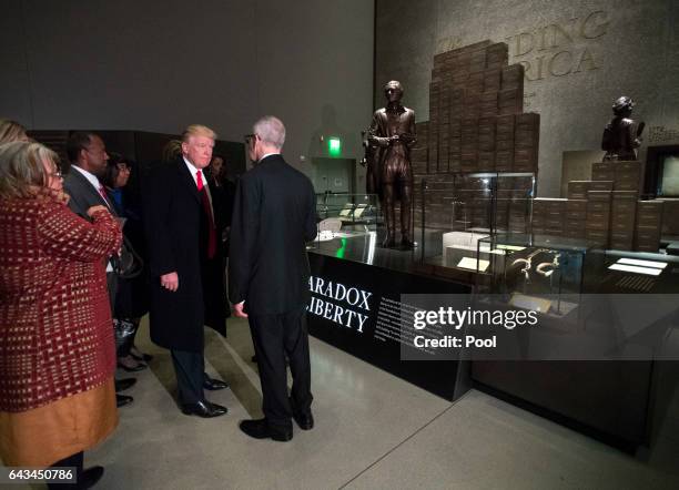 President Donald Trump is joined by David Skorton, Secretary of the Smithsonian, as he tours the Smithsonian National Museum of African American...