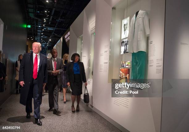 President Donald Trump, joined by Dr. Ben Carson and his wife Candy, visit the Ben Carson exhibit as they tour the Smithsonian National Museum of...