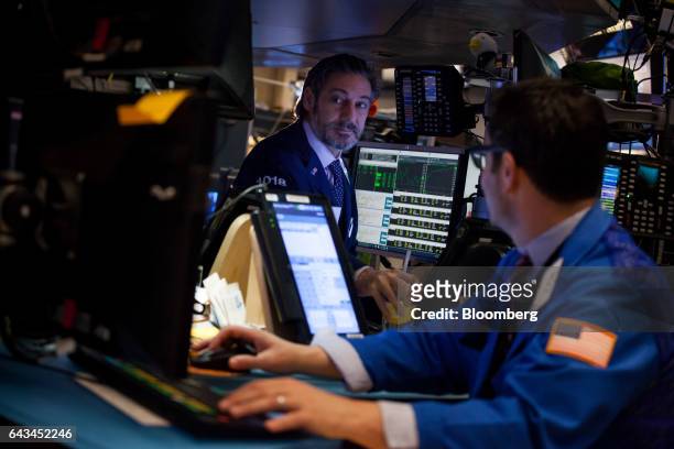 Traders work on the floor of the New York Stock Exchange in New York, U.S., on Tuesday, Feb. 21, 2017. U.S. Stocks rose to records as commodities...