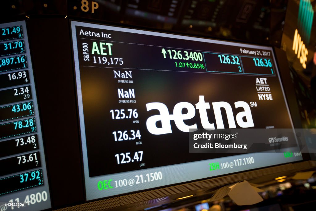 A monitor displays Aetna Inc. signage on the floor of the New York