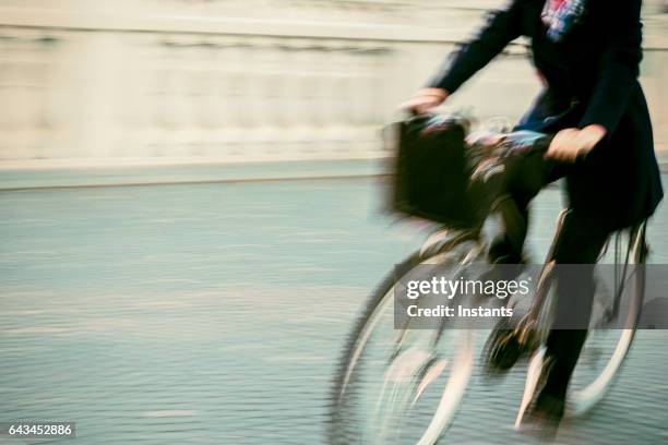 bicycle motion with an unrecognizable person riding on ljubljana prešeren square. - riding stock pictures, royalty-free photos & images