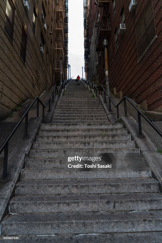 The long stairway goes through among the buildings at The Bronx New York.