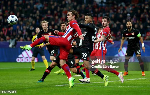 Benjamin Henrichs of Leverkusen and Antoine Griezmann of Atletico battle for the ball during the UEFA Champions League Round of 16 first leg match...