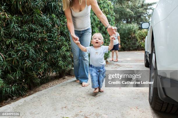 learning to walk with mother's help - learning to walk stockfoto's en -beelden