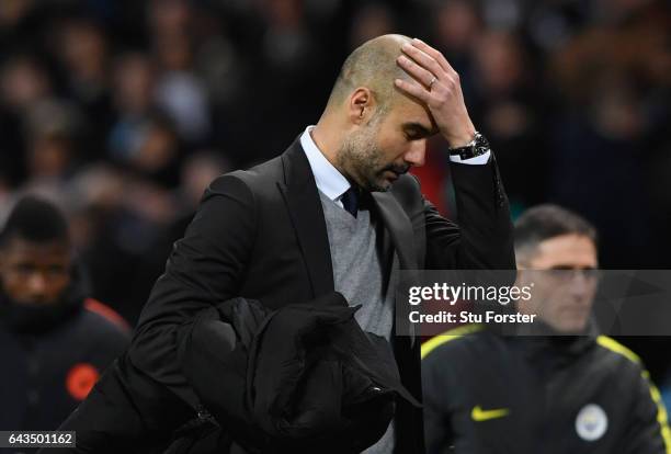 Josep Guardiola manager of Manchester City looks despondent at half time during the UEFA Champions League Round of 16 first leg match between...