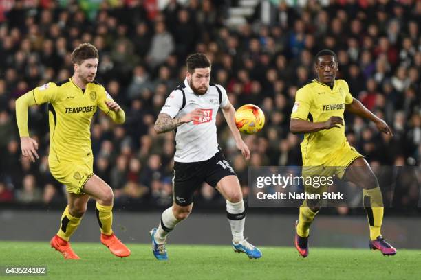 Derby, ENGLANDJacob Butterfield of Derby County and Luke Murphy and Marvin Sordell of Burton Albion in action during the Sky Bet Championship match...