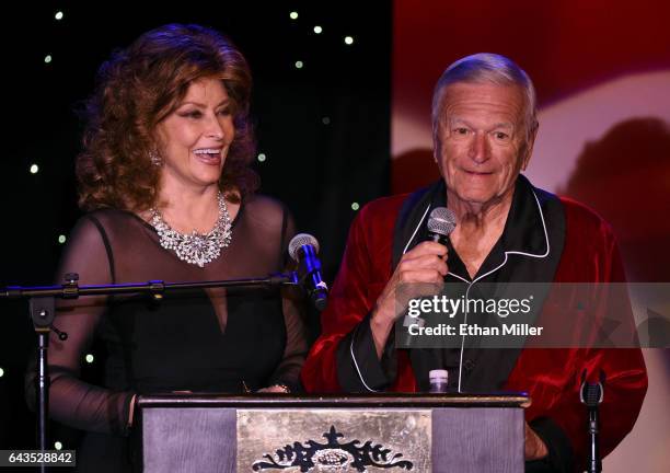 Impersonators Vera Novak of California as Sophia Loren and George Kane of Florida as Hugh Hefner present an award during The Reel Awards 2017 at the...