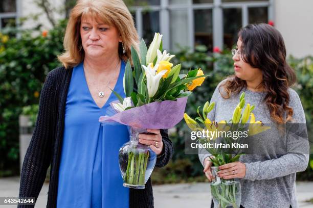 Kelley Williams, left, and Cecilia Alonzo bring flowers at the makeshift memorial for slain Whittier police officer Keith Boyer in front of police...