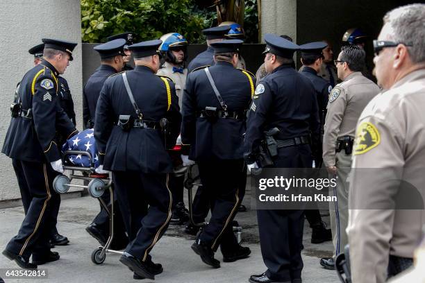 Pall bearers carry casket carrying slain Whittier police officer Keith Boyer into Rose Hill Memorial Park & Mortuaries in Whittier.