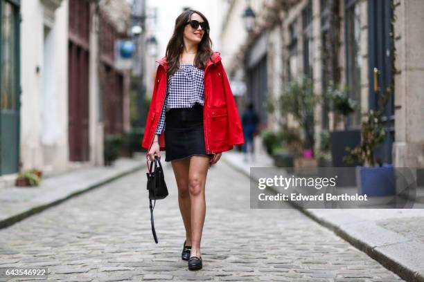 Sarah Benziane, fashion and life style blogger, wears a Newlook red parka coat, a Newlook checked off shoulder top, a Newlook black skirt, Newlook...