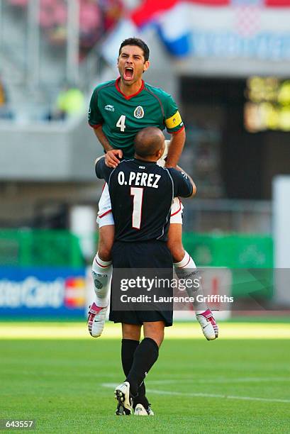 Rarael Marquez of Mexico celebrates with his goalkeeper Oscar Perez after the Mexico goal during the Group G match against Croatia during the World...