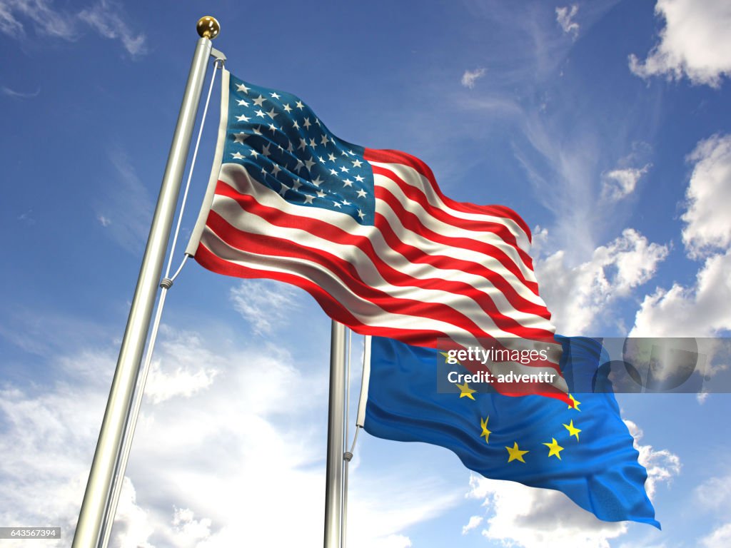 American and European Union flags waving against the sky