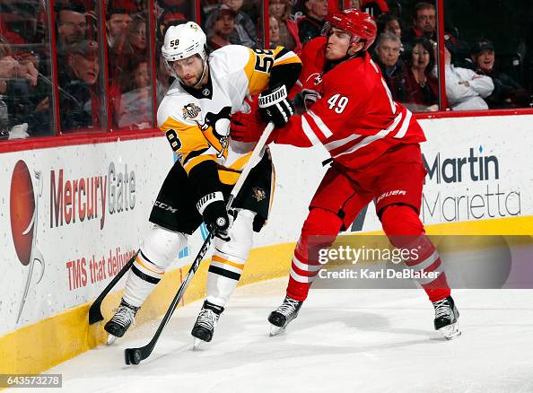 Victor Rask of the Carolina Hurricanes checks puck carrier Kris... News ...