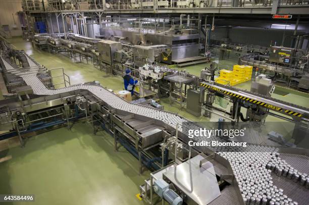 Cans of Asahi Super Dry beer move on the production line of the Asahi Kanagawa Brewery, operated by Asahi Breweries Ltd., a unit of Asahi Group...