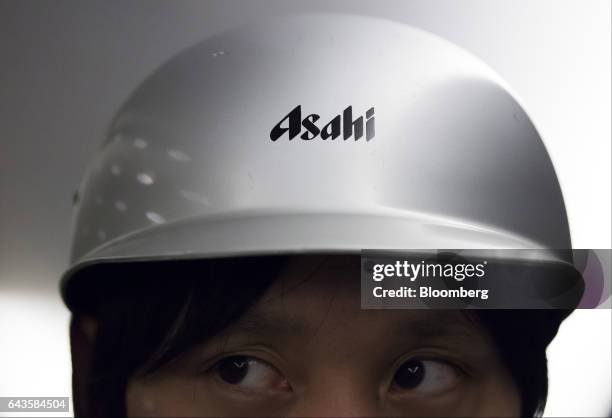 An Asahi Group Holdings Ltd. Logo is seen on a helmet of an employee at the Asahi Kanagawa Brewery, operated by Asahi Breweries Ltd., a unit of Asahi...