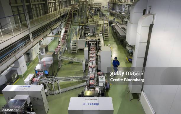 Packages containing cans of Asahi Super Dry beer move on the production line of the Asahi Kanagawa Brewery, operated by Asahi Breweries Ltd., a unit...