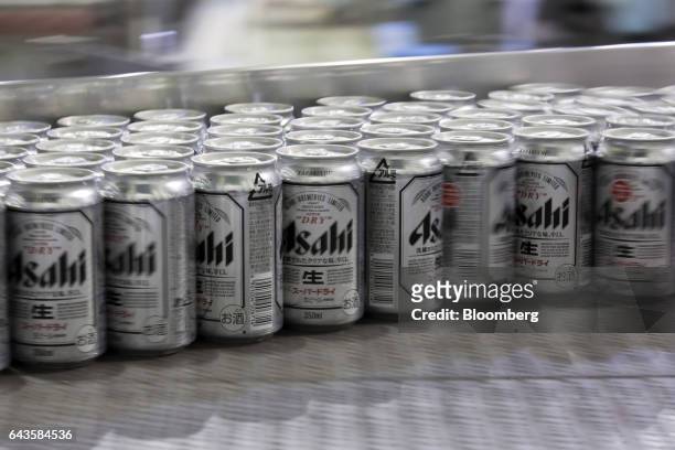 Cans of Asahi Super Dry beer move on the production line of the Asahi Kanagawa Brewery, operated by Asahi Breweries Ltd., a unit of Asahi Group...