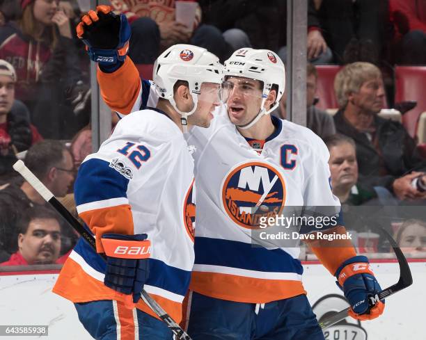 John Tavares of the New York Islanders celebrates his third period goal with teammate Josh Bailey during an NHL game against the Detroit Red Wings at...