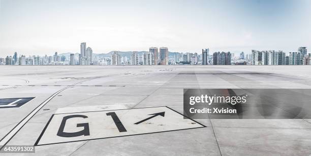 air plane concrete platform with xiamen city as background - flugfeld stock-fotos und bilder