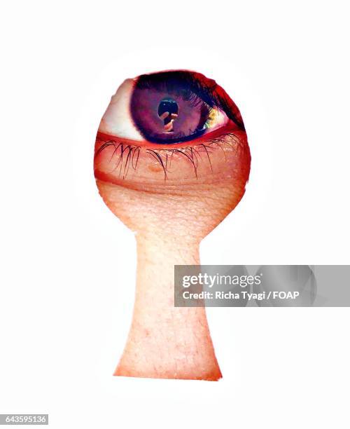 close-up of person looking through keyhole - looking through keyhole stock pictures, royalty-free photos & images