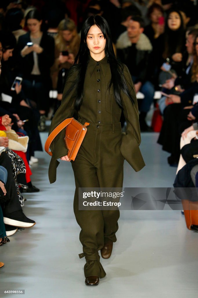 A model walks the runway at the Joseph deigned by Louise Trotter show ...