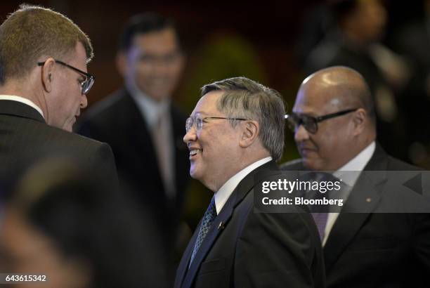 Carlos Dominguez, the Philippines' secretary of finance, center, attends the Asian Development Bank 50th Anniversary reception in Manila, the...