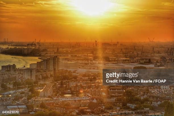 high angle view of city at sunset - hannie van baarle stockfoto's en -beelden