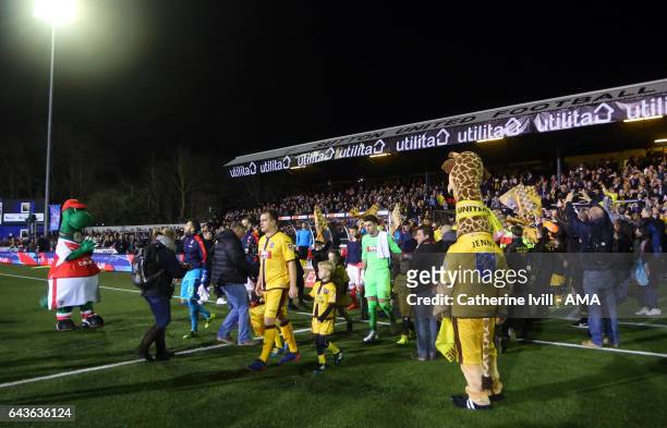 The teams come out onto the pitch during The Emirates FA Cup Fifth Round match between Sutton United and Arsenal on February 20, 2017 in Sutton,...