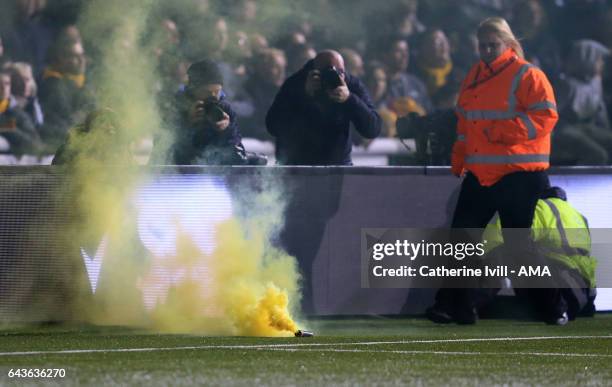 Smoke bomb flare lands on the pitch during The Emirates FA Cup Fifth Round match between Sutton United and Arsenal on February 20, 2017 in Sutton,...