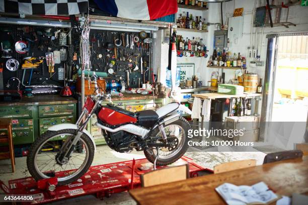 motorcycle in workshop. - motorbike flag stock-fotos und bilder