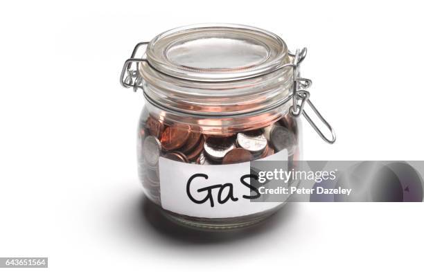 gas jar of money coins - saving for a rainy day englische redewendung stock-fotos und bilder