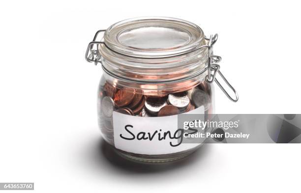 savings jar of money coins - saving for a rainy day englische redewendung stock-fotos und bilder