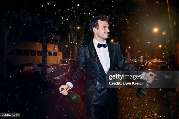 happy young man celebrating on the street - tuxedo stock-fotos und bilder