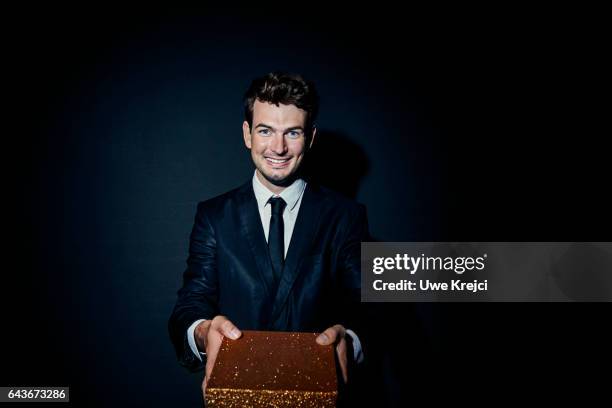 young man holding gift - gift box tag stock-fotos und bilder