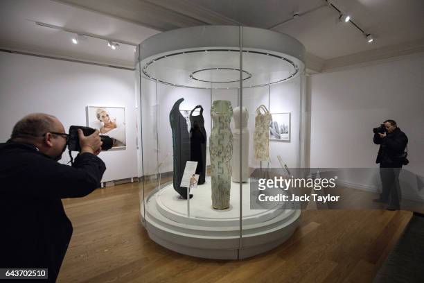 Press photographers take pictures of dresses worn by Princess Diana, including the 1991 Atelier Versace silk gown worn at a Harper's Bazaar...