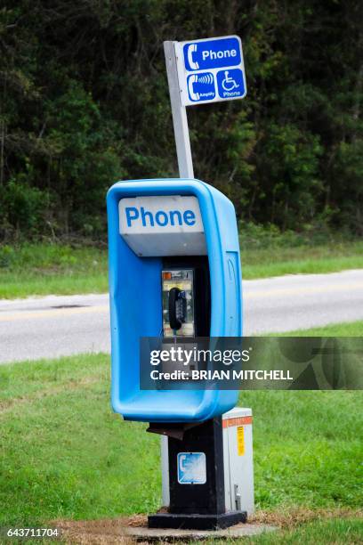 old style north american street pay phone telephone booth on a country road - pay phone stock pictures, royalty-free photos & images