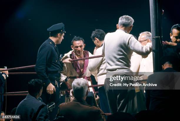 Carmen Basilio of the United States returns to his corner after being introduced before his match against Sugar Ray Robinson for the 1957 World...