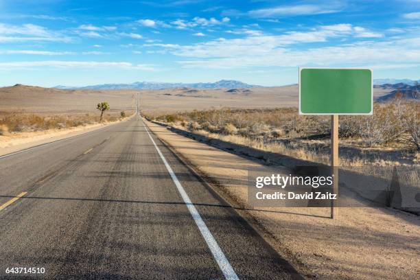 blank sign on desert highway pc rm - road sign foto e immagini stock