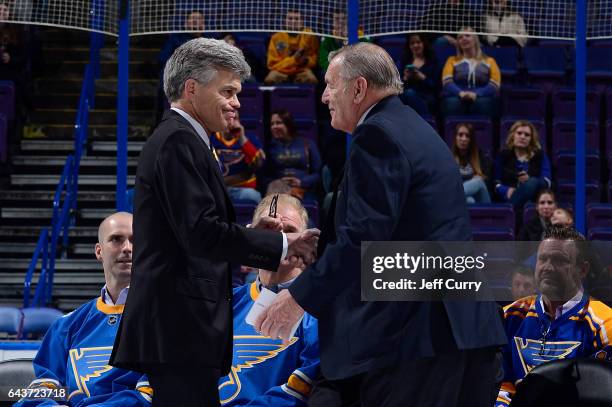 Bob Plager greets Tom Stillman chairman of the St. Louis Blues during Plager's number retirement ceremony prior to a game between the Toronto Maple...