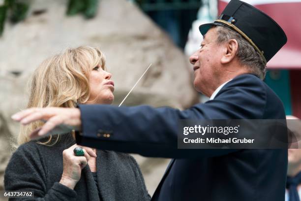 Actress Goldie Hawn conducts a band next to Richard Lugner during an autograph session at Lugner City on February 22, 2017 in Vienna, Austria.