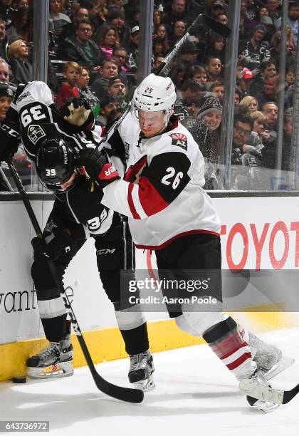 Adrian Kempe of the Los Angeles Kings battles for the puck against Michael Stone of the Arizona Coyotes during the game on February 16, 2017 at...