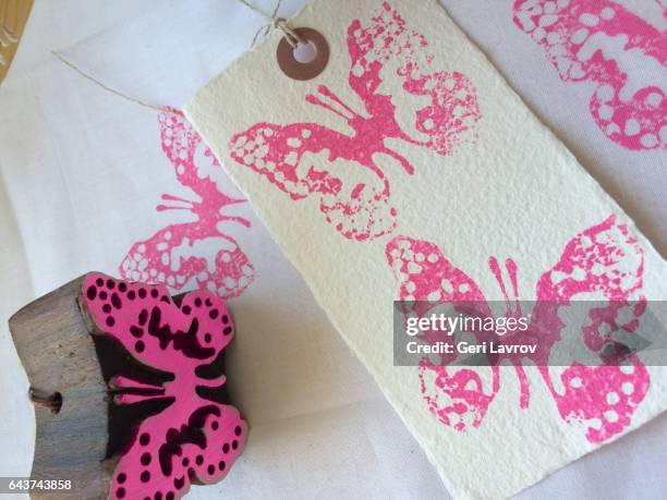 stamping pink butterflies on a paper - サンタイネス ストックフォトと画像
